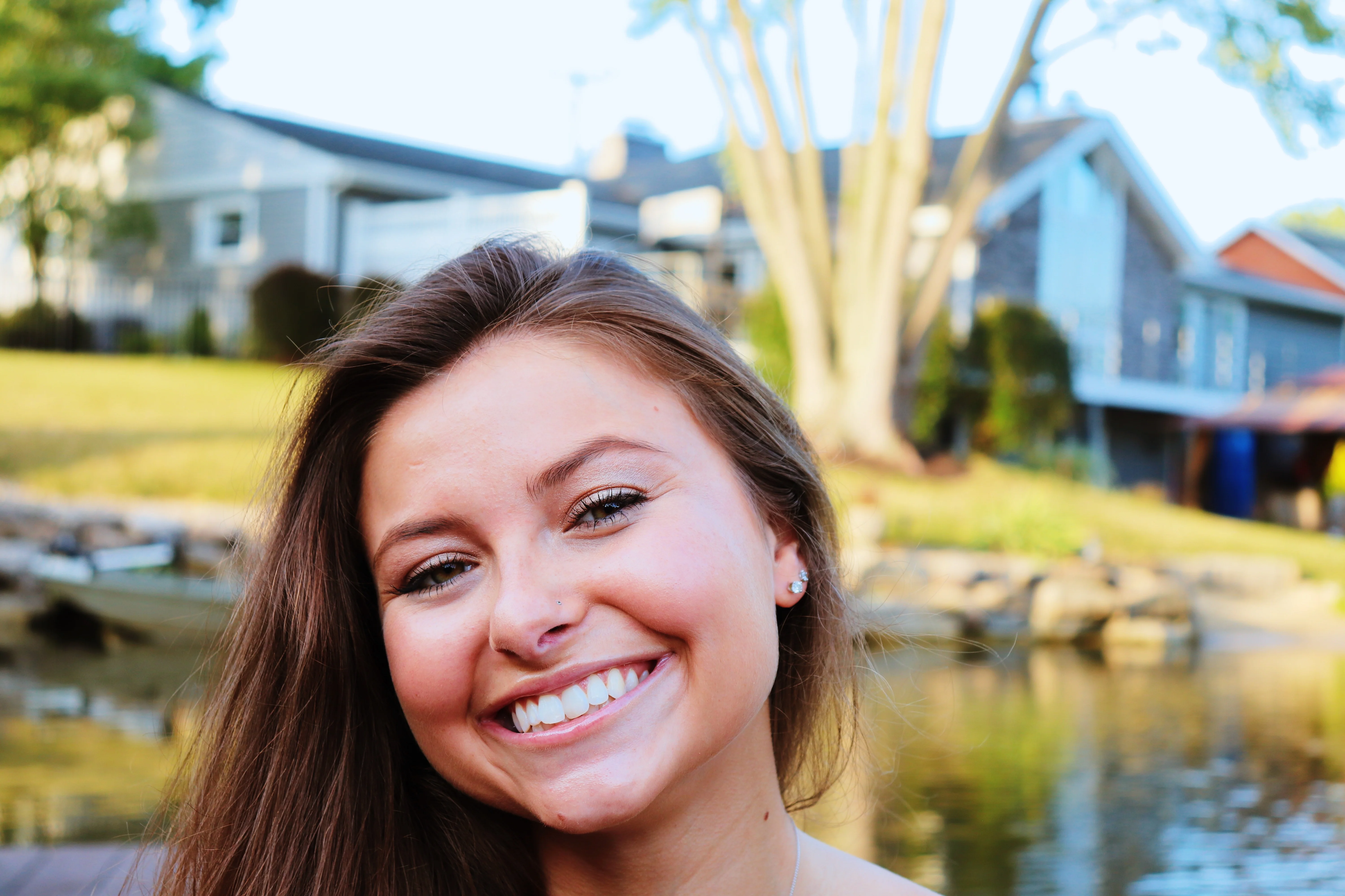 Lauren smiling portrait by the lake